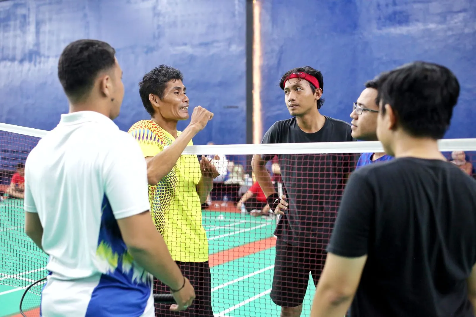 Players on an indoor badminton court