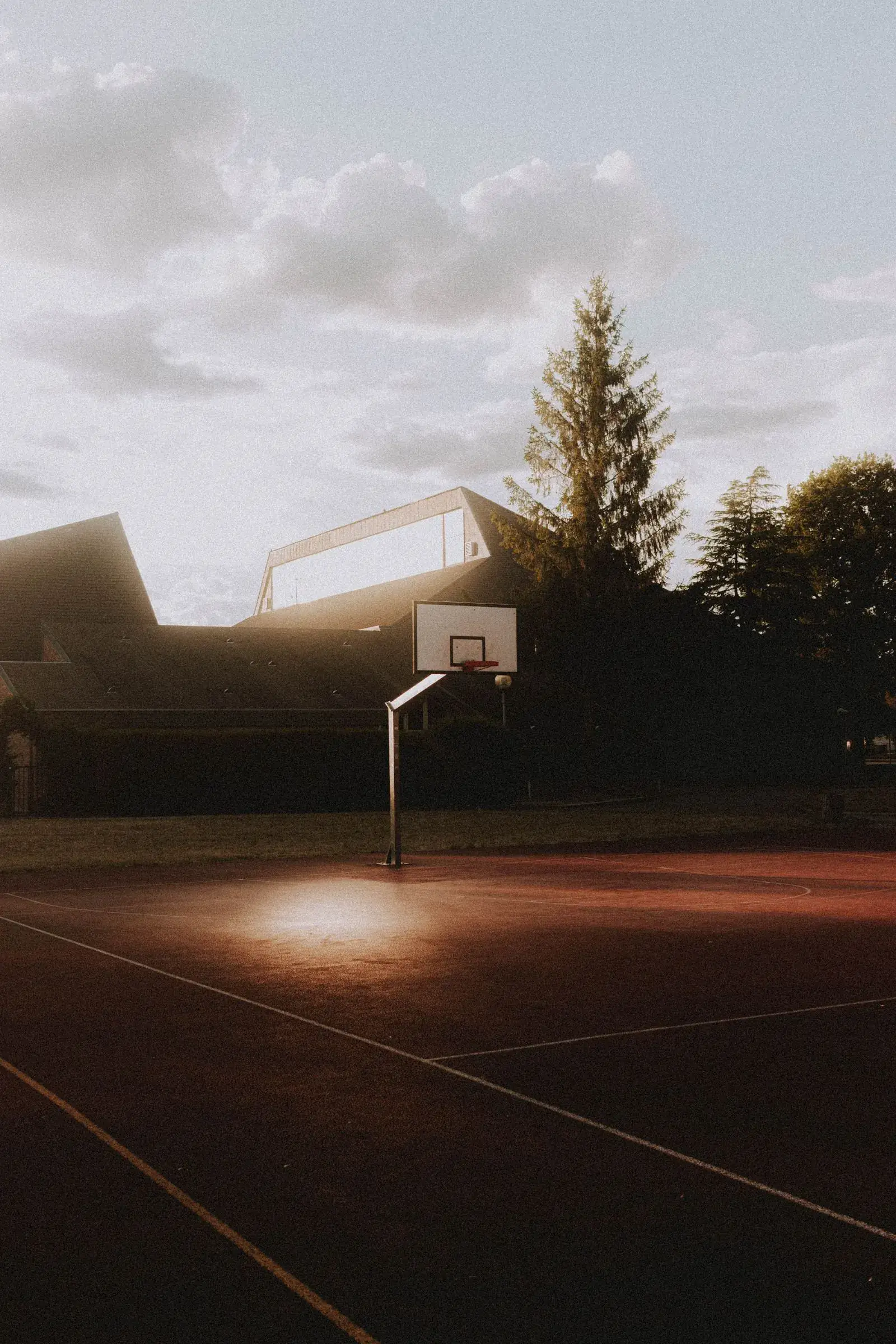 Outdoor basketball hoop at dusk