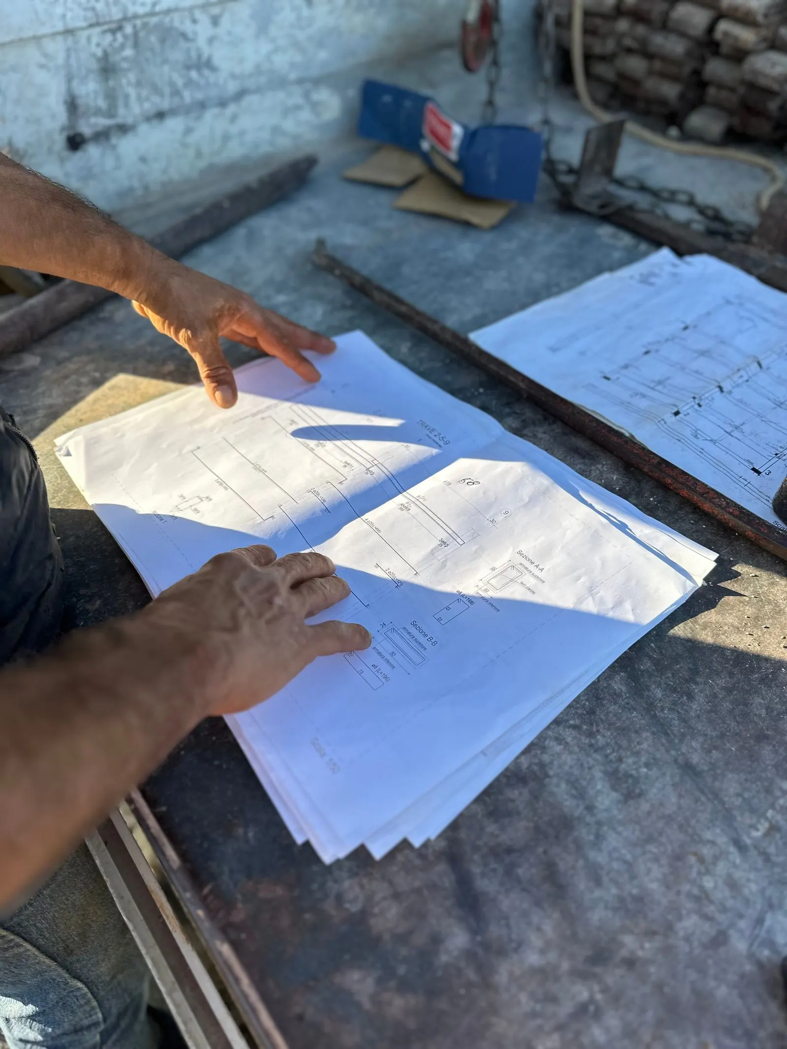 Hands reviewing construction drawings
